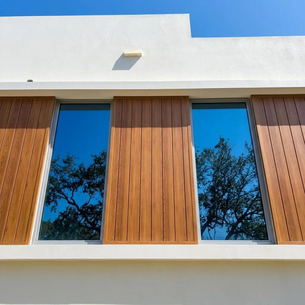 Vertical wood-tone panels flanking a full-height window on white stucco