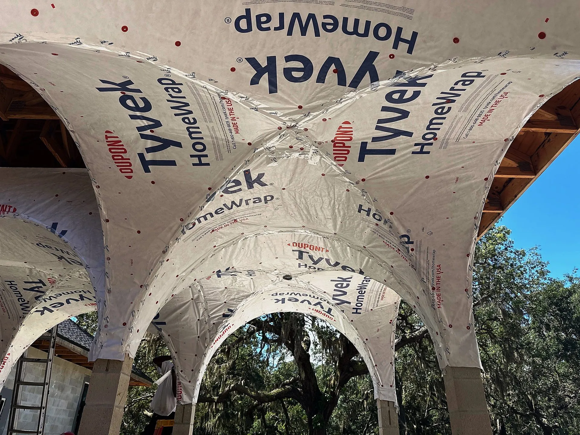 House wrap detailed through an arched entry on a Central Florida build